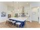 Modern kitchen featuring a large island with seating and white shaker cabinets at 1049 River Wind Cir, Bradenton, FL 34212