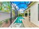 Screened pool area with patio and lush landscaping at 1049 River Wind Cir, Bradenton, FL 34212