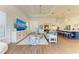 Open concept living room with kitchen, hardwood floors, and a large TV at 1049 River Wind Cir, Bradenton, FL 34212