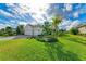White two-story house with a three-car garage and lush landscaping at 1049 River Wind Cir, Bradenton, FL 34212