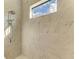 Bright shower with marble tile, a rain shower head, and a window at 1049 River Wind Cir, Bradenton, FL 34212