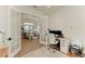 Home office with a desk and French doors opening to the living room at 1049 River Wind Cir, Bradenton, FL 34212
