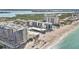 Stunning aerial view showcasing beachfront condo living, a sandy beach, and ocean waters at 1102 Benjamin Franklin Dr # 409, Sarasota, FL 34236