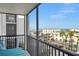 Balcony view overlooking beachside street with beach, ocean, and neighboring buildings at 1102 Benjamin Franklin Dr # 409, Sarasota, FL 34236