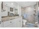 Modern bathroom with tile shower, glass doors, granite vanity, and neutral color palette at 1102 Benjamin Franklin Dr # 409, Sarasota, FL 34236