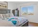 Bright bedroom features a large window offering views of the beautiful blue ocean and beach at 1102 Benjamin Franklin Dr # 409, Sarasota, FL 34236