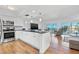 Bright kitchen features stainless steel appliances, granite counters, modern lighting, and overlooks the living area at 1102 Benjamin Franklin Dr # 409, Sarasota, FL 34236