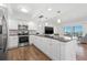 Bright kitchen features stainless steel appliances, granite counters, modern lighting, and overlooks the living area at 1102 Benjamin Franklin Dr # 409, Sarasota, FL 34236