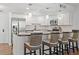 Beautiful kitchen features stainless steel appliances, granite counters, modern lighting, and breakfast bar with seating at 1102 Benjamin Franklin Dr # 409, Sarasota, FL 34236