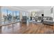 Spacious living room with sliders to balcony, wood-look floors, comfortable seating, and stylish decor at 1102 Benjamin Franklin Dr # 409, Sarasota, FL 34236