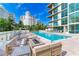 Relaxing pool area with lounge seating and fire pit at 111 Golden Gate Pt # 402, Sarasota, FL 34236