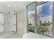 Luxury bathroom with soaking tub, marble shower, and city views at 111 Golden Gate Pt # 402, Sarasota, FL 34236