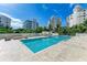Resort-style pool with lounge chairs and fire pit at 111 Golden Gate Pt # 402, Sarasota, FL 34236