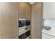 Built-in double oven and microwave in modern kitchen at 111 Golden Gate Pt # 402, Sarasota, FL 34236