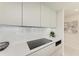 Modern cooktop and range in sleek kitchen setting at 111 Golden Gate Pt # 402, Sarasota, FL 34236