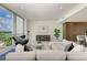 Light-filled living room featuring a comfortable sectional sofa at 111 Golden Gate Pt # 402, Sarasota, FL 34236