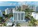 Aerial view of a modern building with pool, near the waterfront at 111 Golden Gate Pt # 402, Sarasota, FL 34236