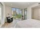 Spacious bedroom with sitting area and large windows offering scenic views at 111 Golden Gate Pt # 402, Sarasota, FL 34236