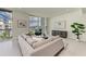 Spacious living room with large windows and city views at 111 Golden Gate Pt # 402, Sarasota, FL 34236