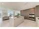 Modern kitchen with island, stainless steel appliances, and wood cabinets at 111 Golden Gate Pt # 402, Sarasota, FL 34236