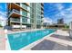 Modern building with refreshing pool and seating area at 111 Golden Gate Pt # 402, Sarasota, FL 34236