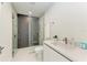 Modern bathroom with a frameless shower and white vanity at 111 Golden Gate Pt # 402, Sarasota, FL 34236