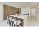 Modern kitchen featuring an island and stainless steel appliances at 111 Golden Gate Pt # 402, Sarasota, FL 34236