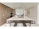 Modern kitchen with island, stainless steel appliances, and wood cabinetry at 111 Golden Gate Pt # 402, Sarasota, FL 34236