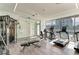 Bright gym featuring modern exercise equipment, wood flooring, and floor-to-ceiling windows offering scenic views at 111 Golden Gate Pt # 402, Sarasota, FL 34236