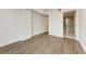 Bedroom with wood-look floors and access to bathroom at 111 Golden Gate Pt # 402, Sarasota, FL 34236
