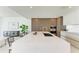 Modern kitchen with white quartz island and wood cabinets at 111 Golden Gate Pt # 402, Sarasota, FL 34236