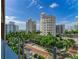 View from balcony showcasing cityscape and palm trees at 111 Golden Gate Pt # 402, Sarasota, FL 34236