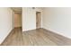 Bedroom with wood-look floors and access to bathroom and hallway at 111 Golden Gate Pt # 402, Sarasota, FL 34236