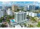 Modern building with pool; aerial view overlooking the city at 111 Golden Gate Pt # 402, Sarasota, FL 34236