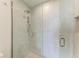 Modern shower with glass enclosure and rainfall shower head at 111 Golden Gate Pt # 402, Sarasota, FL 34236