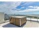 Relax in this rooftop hot tub with stunning water views at 111 Golden Gate Pt # 402, Sarasota, FL 34236