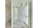 Large walk-in shower with marble tile and glass enclosure at 111 Golden Gate Pt # 402, Sarasota, FL 34236