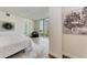Main bedroom with plush bed, wood floors, and large window with city view at 111 Golden Gate Pt # 402, Sarasota, FL 34236