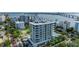 Aerial view of a modern highrise building with a pool and waterfront location at 111 Golden Gate Pt # 402, Sarasota, FL 34236