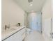 Modern bathroom with a frameless shower and white vanity at 111 Golden Gate Pt # 402, Sarasota, FL 34236