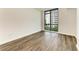 Bright bedroom with a large window and wood-look floors at 111 Golden Gate Pt # 402, Sarasota, FL 34236
