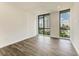 Bright bedroom with large windows, city views, and wood-look floors at 111 Golden Gate Pt # 402, Sarasota, FL 34236