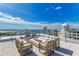 Rooftop terrace with fire pit and comfortable seating for lounging at 111 Golden Gate Pt # 402, Sarasota, FL 34236