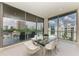 Modern dining area with glass table and city views at 111 Golden Gate Pt # 402, Sarasota, FL 34236