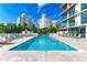 Inviting pool area with ample lounge chairs at 111 Golden Gate Pt # 402, Sarasota, FL 34236