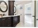 Elegant bathroom featuring dual sinks, a marble countertop, and ample cabinet space for storage at 117 Hillcrest Dr, Bradenton, FL 34209