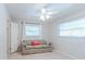 Bright bedroom with white ceiling fan, a sofa, and natural light from a window at 117 Hillcrest Dr, Bradenton, FL 34209