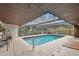 Inviting screened-in pool area featuring a unique overhead design and an easy access ladder at 117 Hillcrest Dr, Bradenton, FL 34209