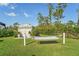 Landscaped backyard featuring a hammock and charming storage shed at 13380 Rayburn Ln, Port Charlotte, FL 33981