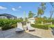 Relaxing backyard patio with lounge chairs and umbrella, perfect for outdoor entertaining at 13380 Rayburn Ln, Port Charlotte, FL 33981